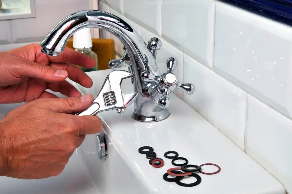 Plumber performing maintenance on a bathroom faucet in Coachella