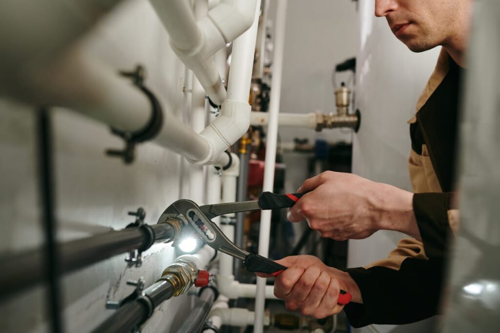 Plumbers maintaining commercial plumbing pipes in Coachella