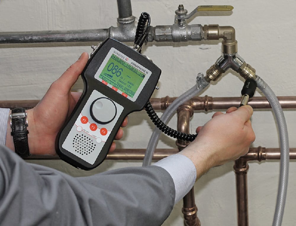 Plumber testing pipes with electronic leak detection equipment in Coachella