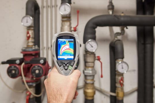 Plumber using a thermal imaging camera to inspect pipes in Coachella