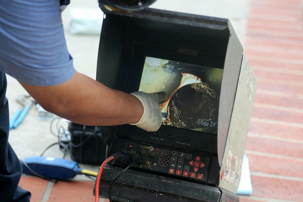 Technician viewing a drain inspection camera in Coachella