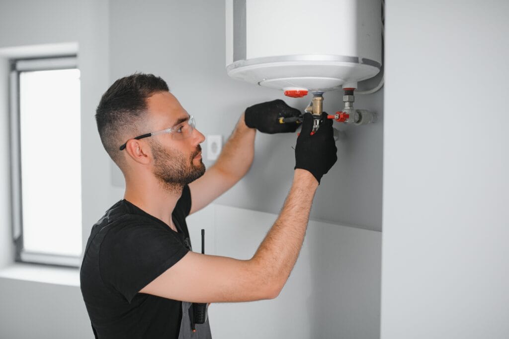 Technician performing water heater maintenance in Coachella