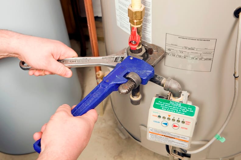 Plumber repairing a water heater valve in Coachella